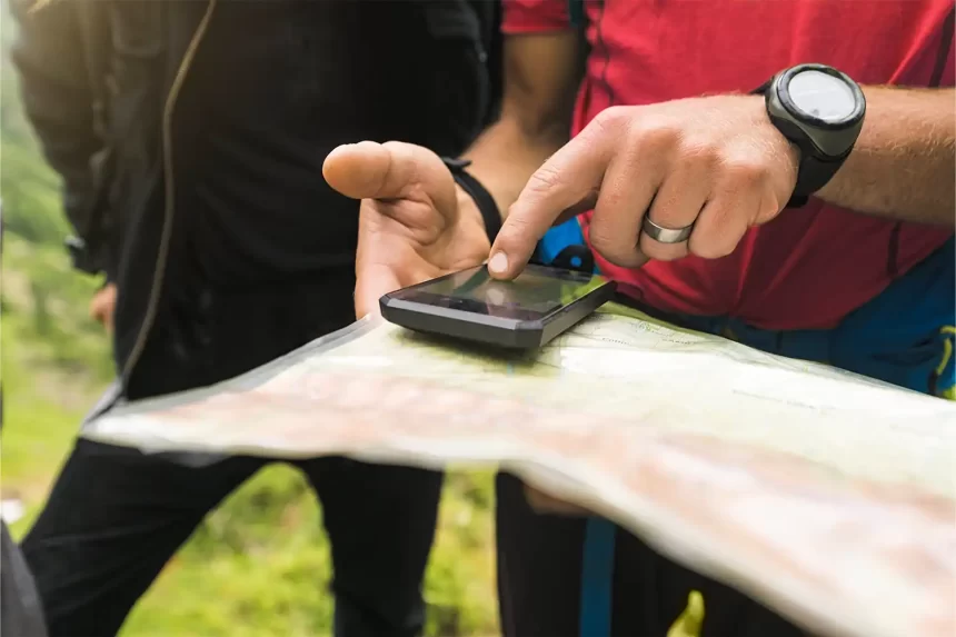 Hiker using AI travel app in mountains 2025